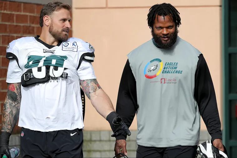 Eagles' Chris Long, left, and Michael Bennett, right, talks during Eagles Training Camp at the NovaCare Complex in Philadelphia, PA on August 1, 2018. DAVID MAIALETTI / Staff Photographer