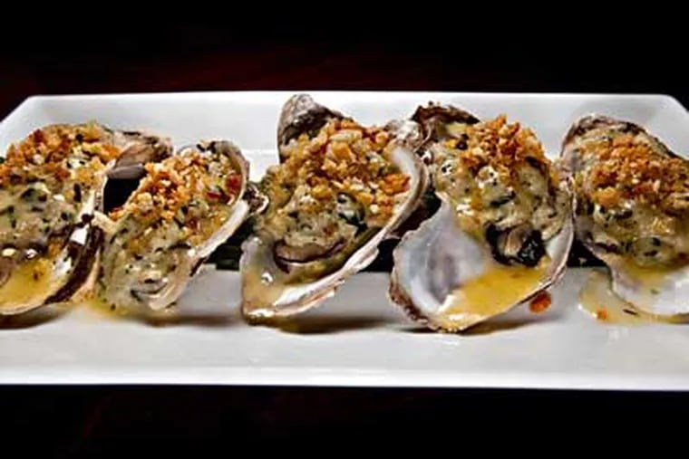 Roast oysters with crabmeat stuffing, saffron and thyme. (DAVID M WARREN / Staff Photographer)