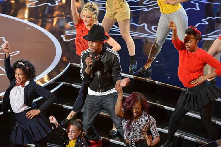 Pharrell Williams is surrounded by dancers as he performs 'Happy' during the awards program.
