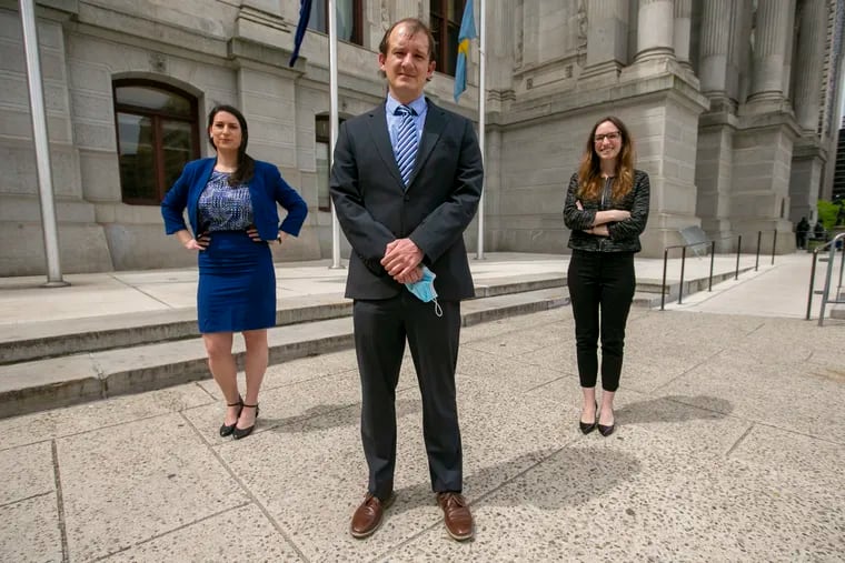 Supervisor Jonah Eaton, and two staff attorneys, Maggie Kopel (in black) and Lilah Thompson, at Philadelphia City Hall on Wednesday, May 20. Facing pandemic-driven budget deficits, the Kenney administration has eliminated $200,000 in funding for the Pennsylvania Immigrant Family Unity Project, which provides free legal representation for migrants facing deportation.