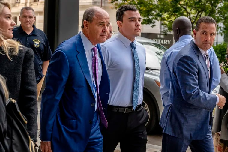 In this file photo from 2023, former Philadelphia Police Officer Mark Dial (center) walks with his lawyers outside the courthouse.