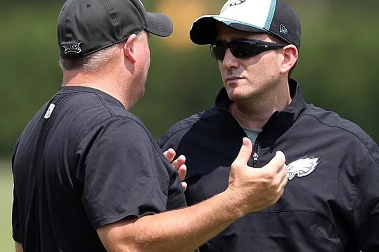 Eagles head coach Chip Kelly talks to general manager Howie Roseman. (David Maialetti/Staff Photographer)