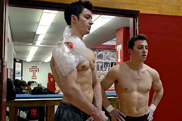 Temple University men's gymnastics junior Colton Howard (left) and spophomore Evan Eigner (right) pause aftter working out at the school December 6, 2013. In a stunning move, Temple killed seven of its 24 intercollegiate sports programs including men's gymnastics.  ( TOM GRALISH / Staff Photographer )