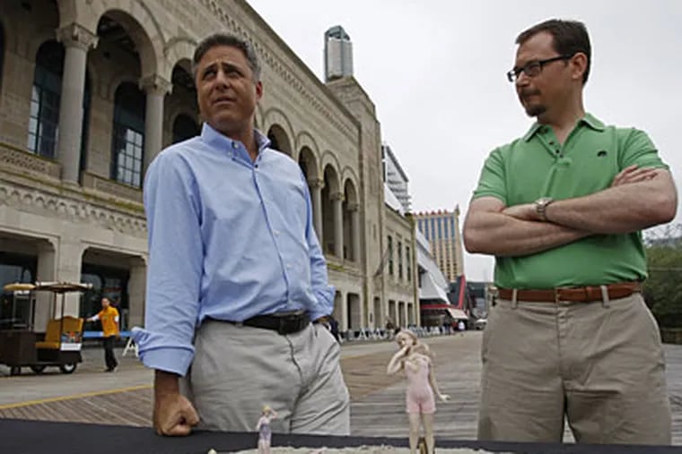 Mark Walberg, left, host of "Antiques Roadshow," and Andy Ourant, an antiques expert from Adamstown, Pa., discuss bisque German bathing beauty figurines, which were sold on the Atlantic City Boardwalk for pennies around 1900. (Michael S. Wirtz / Staff Photographer)
