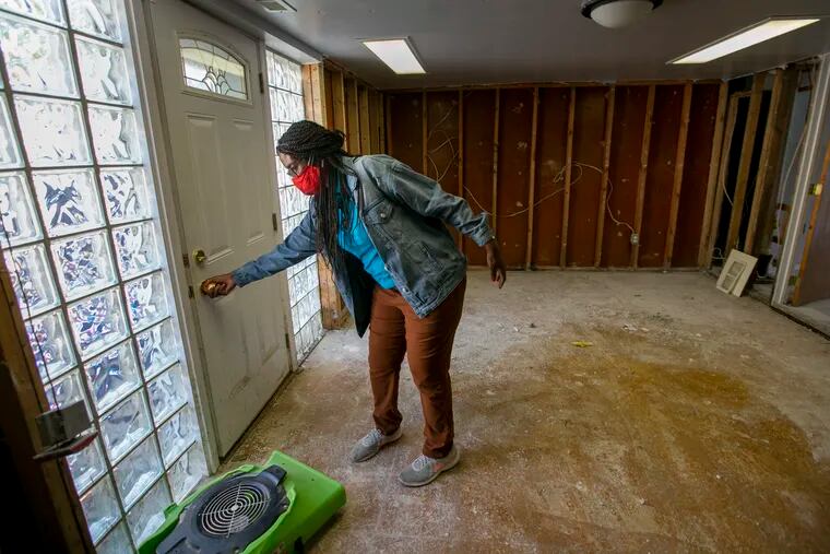 Jennifer Nesbitt, resident of 8000 block of Buist in Eastwick section of Philadelphia shows the water damage from Tropical Storm Isaias to her basement on Wednesday, August 19, 2020.