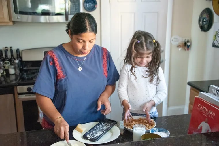 Jessica van Dop DeJesus and her daughter prepare dinner. With preschool on hold, Lu, 3 1/2 is learning to cook at home.