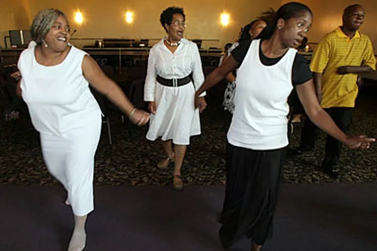 Dancers move their feet while line dancing at Club Destiny at the
Eastwick Worship Center this summer. ( Yong Kim /
Staff Photographer )