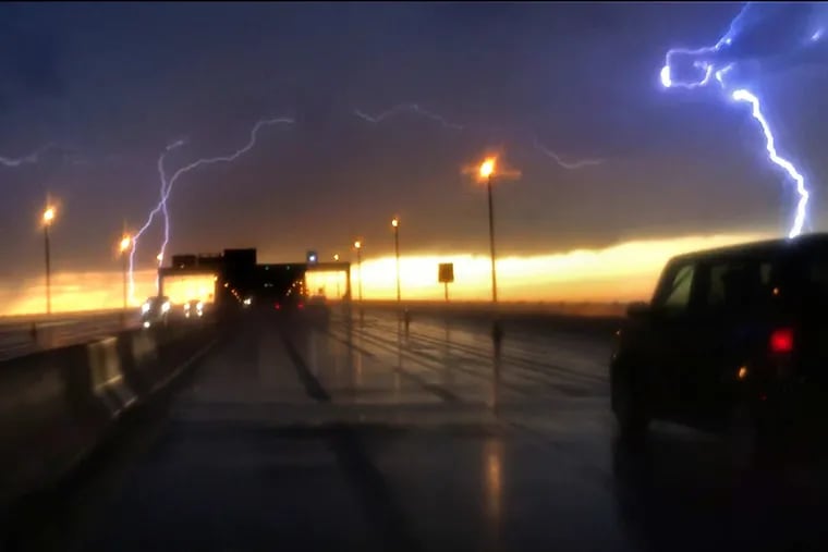 Seen from the Betsy Ross Bridge, lightning strikes flash over Port Richmond and Bridesburg in May 2018. Lightning evidently killed a golfer in Burlington County on Wednesday.