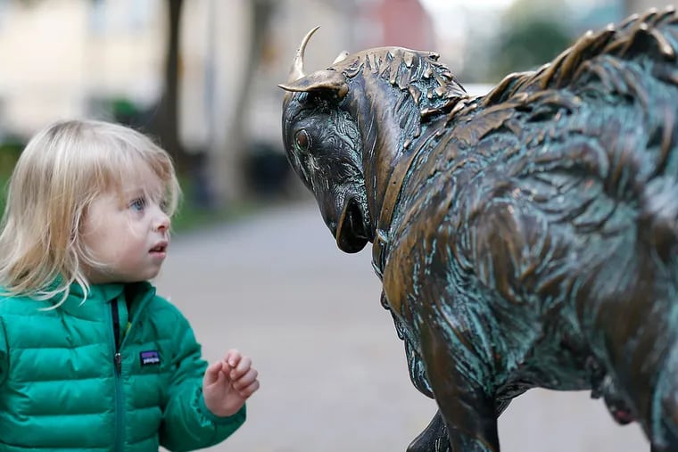 Audrey Petrilli checks out Billy, the Rittenhouse Square goat sculpture, which may soon be moved indoors and replaced with a recast replica.