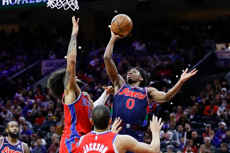 Sixers guard Tyrese Maxey drives to the basket against Detroit Pistons forward Isaiah Livers (left) and guard Frank Jackson in the third quarter.