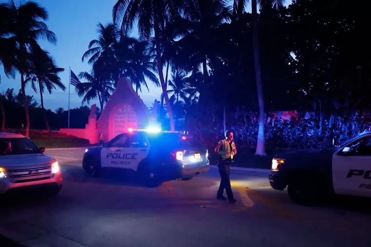 Police direct traffic outside an entrance to former President Donald Trump's Mar-a-Lago estate in Palm Beach, Fla., on Monday. Trump said in a statement that the FBI was conducting a search of the estate.