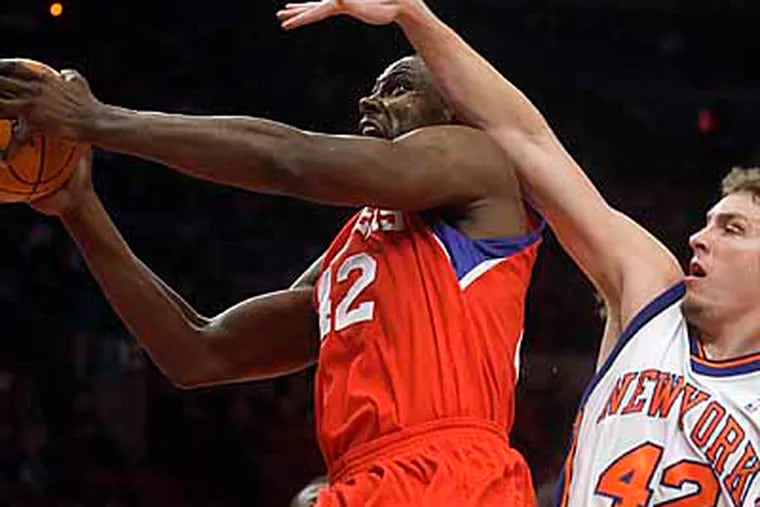 Philadelphia 76ers' Elton Brand (42) drives past New York Knicks' David Lee (42) and Al Harrington (7) during the first half of a preseason NBA basketball game Tuesday, Oct. 13, 2009, in New York. Brand scored 20 points as the 76ers won 93-85. (AP Photo/Frank Franklin II)