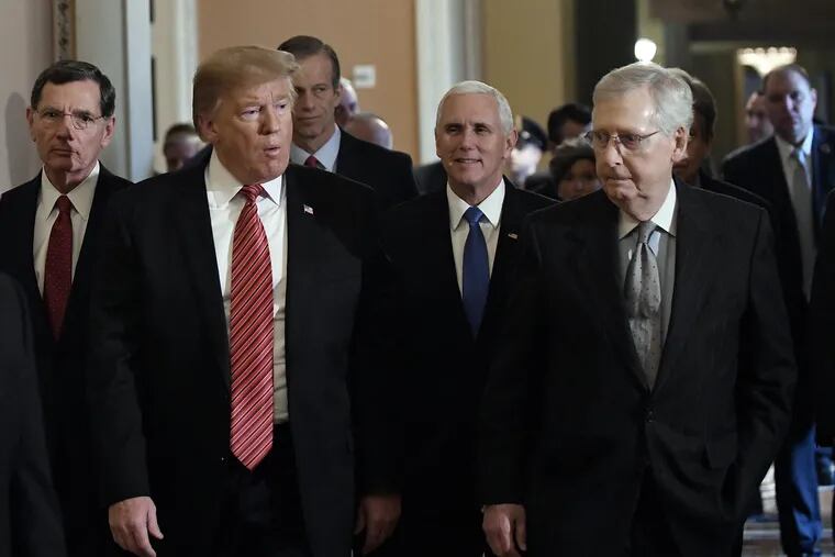 President Donald Trump walks with Senate Majority Leader Mitch McConnell (R., Ky.) and Vice President Mike Pence after the Republican luncheon at the U.S. Capitol Building on Wednesday.