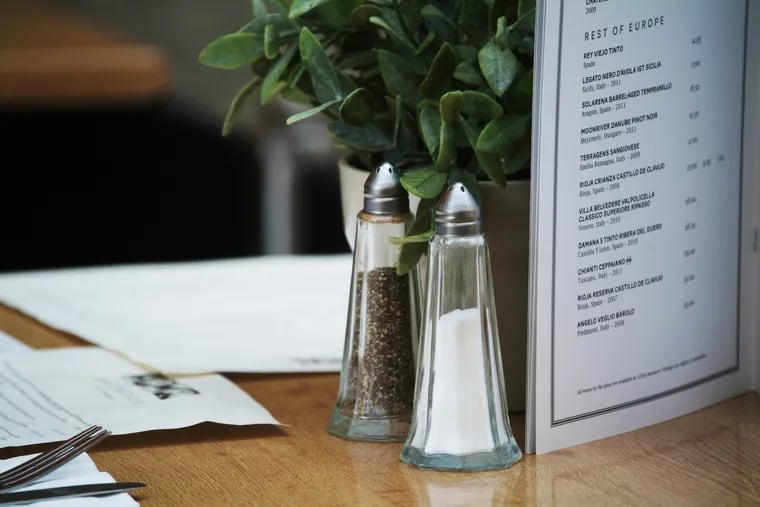Salt and pepper on a restaurant table.