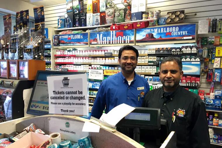Sunoco APlus manager Khurram Aijaz (left) and Mohammad Chaudhary, who sold the $1 million winner. (LAURA McCRYSTAL / Staff)