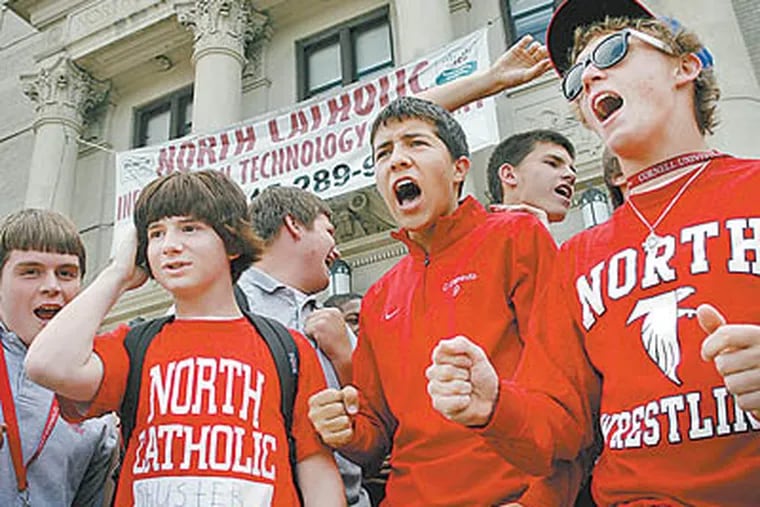 At Northeast Catholic High School for Boys, students (from left) Max Shuster, Christian Cepeda, and Eric Stankiewicz protest closing plans. (Alejandro A. Alvarez / Staff Photographer)
