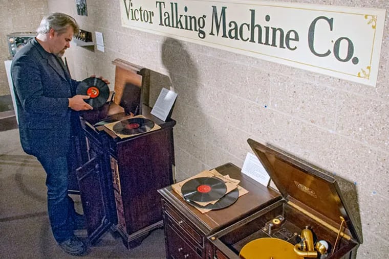Stefan Arnarson, music instructor and a co-curator of the "Sounds of Camden" exhibit at the Stedman Gallery at Rutgers-Camden, puts a record of his grandmother's onto a Victrola record player. CLEM MURRAY / Staff Photographer