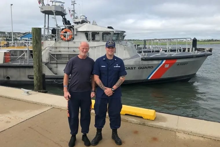 Duncan Hutchinson. left, safe on shore with Coast Petty Officer 2nd Class Eric Thornton at the Coast Guard Station Barnegat Light. 