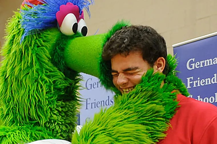 Top Phillies pick Jesse Biddle is kissed by the Phanatic at Germantown Friends School. (Clem Murray/Staff Photographer)
