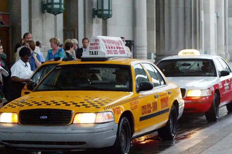 Taxi's pick up Amtrak passengers outside 30th st. station.