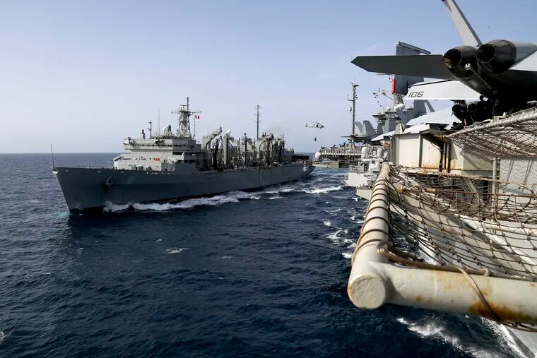 ADDS LOCATION - In this Sunday, May 19, 2019, photo released by the U.S. Navy, the fast combat support ship USNS Arctic transports cargo to the Nimitz-class aircraft carrier USS Abraham Lincoln during a replenishment-at-sea in the Arabian Sea. (Mass Communication Specialist 3rd Class Jeff Sherman/U.S. Navy via AP)