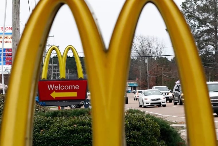 FILE – This Feb. 15, 2018, file photo shows a McDonald's Restaurant in Brandon, Miss. Seven national fast-food chains have agreed to end policies that block workers from changing branches, limiting their wages and job opportunities, under the threat of legal action from several attorneys general.  (AP Photo/Rogelio V. Solis, File)