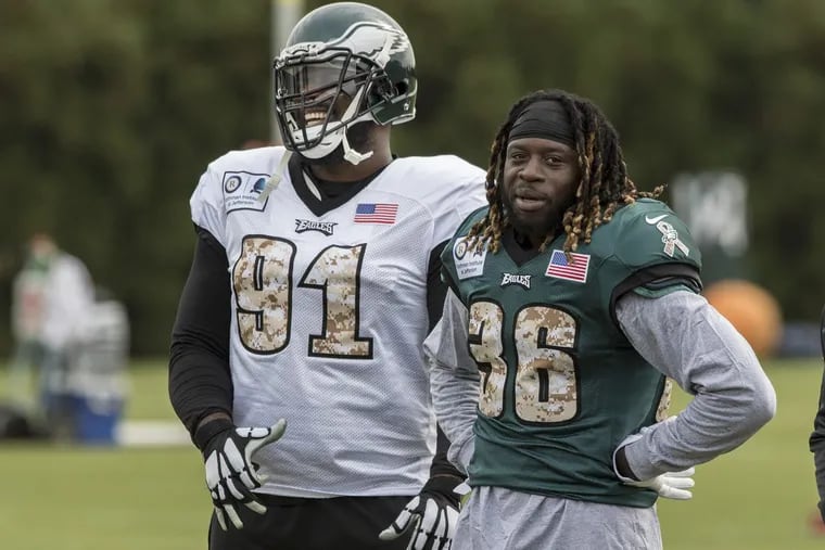 Eagles all-pro defensive tackle Fletcher Cox has a laugh with newly acquired Eagles running back Jay Ajayi during his first practice with the Eagles at the NovaCare Complex November 1, 2017. Ajayi was acquired in a trade with the Miami Dolphins. CLEM MURRAY / Staff Photographer