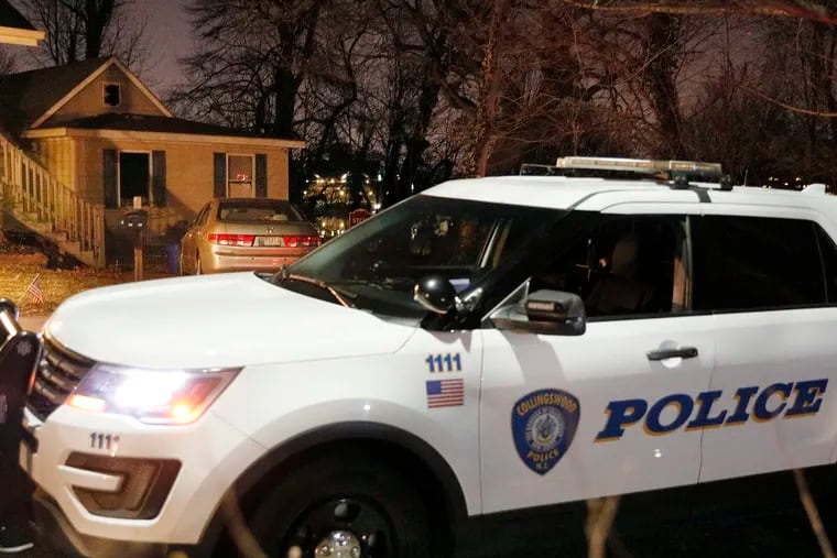 A Collingswood police car is posted outside the home where an intruder attacked one person and tied up another before setting a fire in the house and fleeing on Sunday, Feb. 23, 2020.