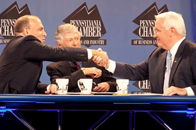 Gubernatorial candidates Dan Onorato (left), a Democrat, and Tom Corbett, a Republican, shake hands in front of moderator Ted Koppel after their debate at the Hotel Hershey in Hershey, Pa. (DANIEL SHANKEN / AP)
