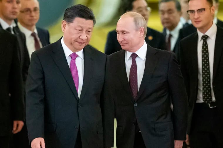 Russian President Vladimir Putin, center right, and Chinese President Xi Jinping, center left, enter a hall for the talks in the Kremlin in Moscow, Russia in June 5, 2019. Putin and Xi have established themselves as the world’s most powerful authoritarian leaders in decades—and is getting further help from President Trump, writes Trudy Rubin.
