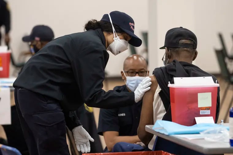 Philadelphia Fire Department EMS Paramedics administer the Johnson and Johnson vaccine during a neighborhood vaccine clinic in West Oak Lane in March.