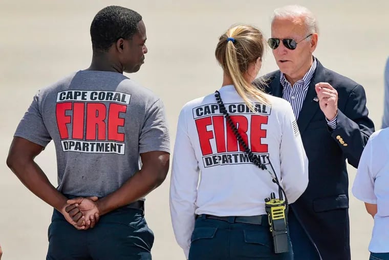 President Joe Biden greets Cape Coral firefighters on the runway of Southwest Florida International Airport in Fort Myers after Hurricane Ian in October 2022. Biden will meet with firefighters in Philadelphia on Monday to announce additional grant money to reopen several shuttered companies.