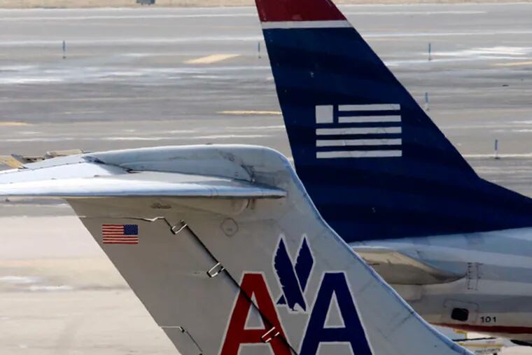 The Justice Department has settled a lawsuit that challenged the pending merger of American Airlines and US Airways. The latter is the dominant carrier at Philadelphia International Airport. (Matt Rourke / AP)