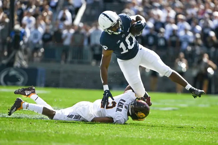 Penn State running back Nicholas Singleton is tackled by Central Michigan defensive back Ronald Kent Jr. during the first half Saturday.