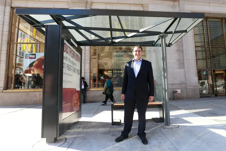 Andrew Stober, an independent candidate for City Council at large, inside the prototype bus shelter at Broad and Arch Streets.