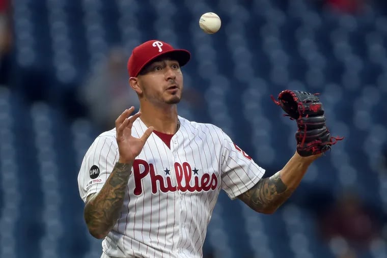 Phillies' starter Vince Velasquez stops a line drive off the bat of the Pirates' Kevin Newman hitting it with his glove and making the catch with his bare right hand.