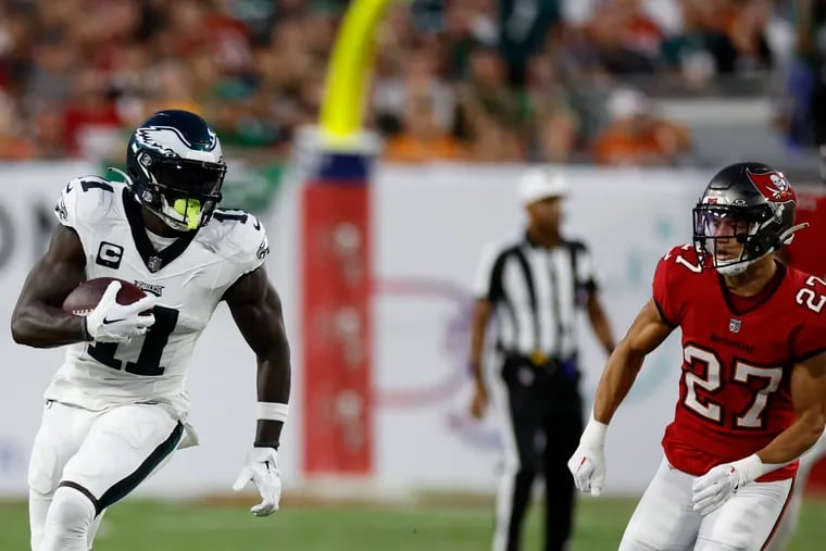Eagles wide receiver A.J. Brown is pursued by Buccaneers cornerback Zyon McCollum in the first quarter at Raymond James Stadium.