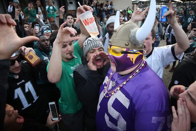 Vikings fan Andrew Grein walked through a crowd of hostile Eagles fans before kickoff of the NFC Championship Game at Lincoln Financial Field in Philadelphia on Sunday.