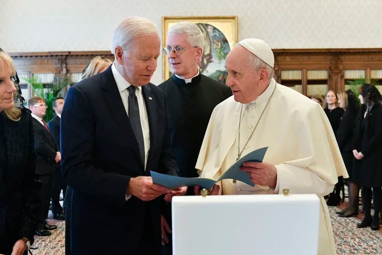 President Joe Biden exchanges gifts with Pope Francis during Friday's meeting at the Vatican.