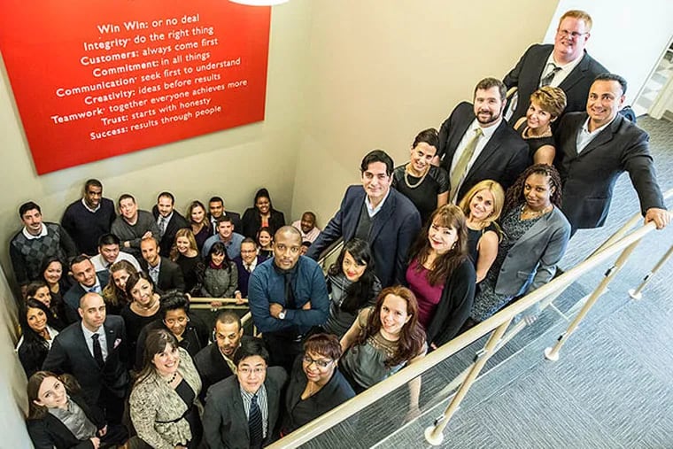 The employees of Keller Williams Realty in their Philadelphia office. (Colin Kerrigan / Philly.com)