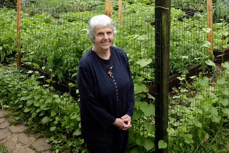 Sister Margaret McKenna stands near her garden at the New Jerusalem Now rehab program in North Philadelphia.