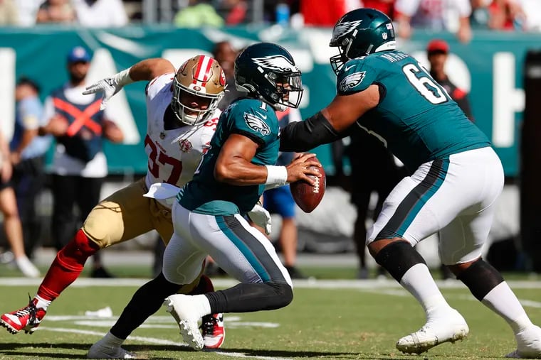 Eagles quarterback Jalen Hurts runs as tackle Jordan Mailata blocks 49ers defensive lineman Nick Bosa on Sept. 19, 2021.