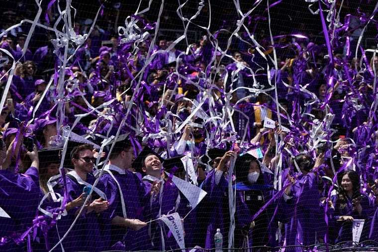 Confetti drops on graduates as they celebrate during a graduation ceremony for New York University at Yankee Stadium on May 18, 2022.