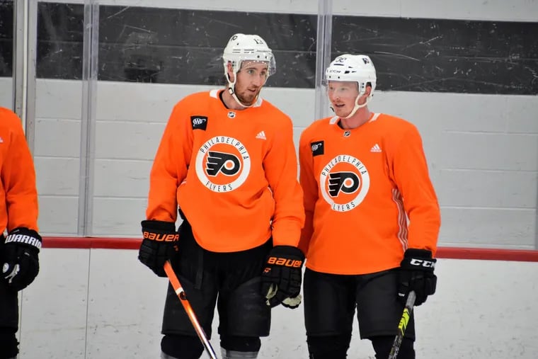 Kevin Hayes, left, speaks with his new Philadelphia Flyers teammate Patrick Brown, whom he played with at Boston College.