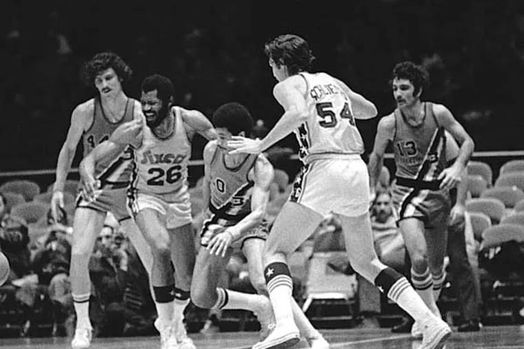 Philadelphia 76ers Manny Leaks (26) seems displeased with himself after letting the ball get away in the first half of an NBA game against Buffalo in Philadelphia on Sunday, Jan. 28, 1973. Sixer Dale Schlueter (54) and Braves Bob Kauffman (44) and Dick Garrett (20) make their moves to recover the loose ball. (BH/AP)
