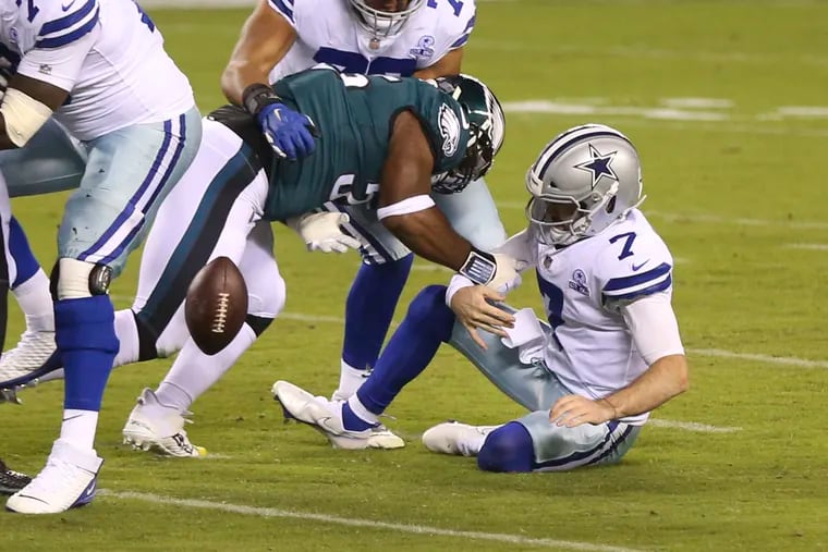 Eagles defensive end Brandon Graham forced a fumble after hitting Cowboys quarterback Ben DiNucci (7) on Sunday night.