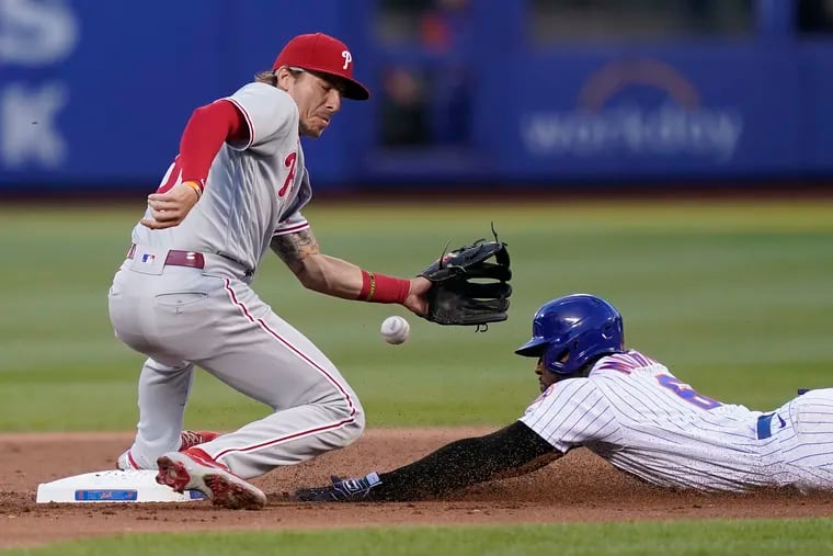 Phillies second baseman Bryson Stott (left) misses the throw to second on a steal attempt by New York Mets' Starling Marte. Marte took third on the play.