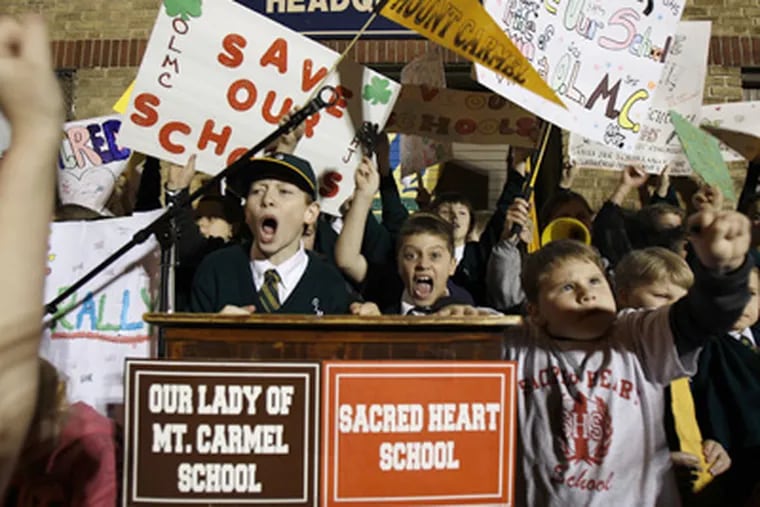 Students cheer during a rally at 3rd and McKean streets in Philadelphia on Feb. 23 to protest the planned closing of Our Lady of Mount Carmel School and Sacred Heart of Jesus School. (David Maialetti  / Staff Photographer)