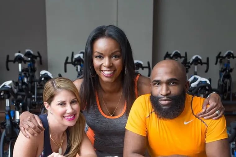 From left to right: Mindie Barnett of MB & Associates PR, Inquirer columnist Jenice Armstrong, and celebrity fashion stylist Anthony Henderson-Strong pose during a 2017 singles photo shoot at Lifetime Fitness in Fort Washington, Pa.