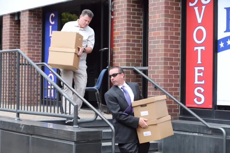FBI employees carry out boxes from the offices of the International Brotherhood of Electrical Workers Local 98 in Philadelphia on Friday, Aug. 5, 2016. About 100 boxes - with some labeled "bank statements" and "taxes" - were loaded into a rental truck along with four computers.
